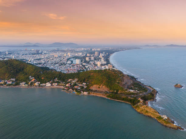 istock Panoramic coastal Vung Tau view from above, with waves, coastline, streets, coconut trees, Mount Nho in Vietnam behind the statue of Christ the King 1864669950