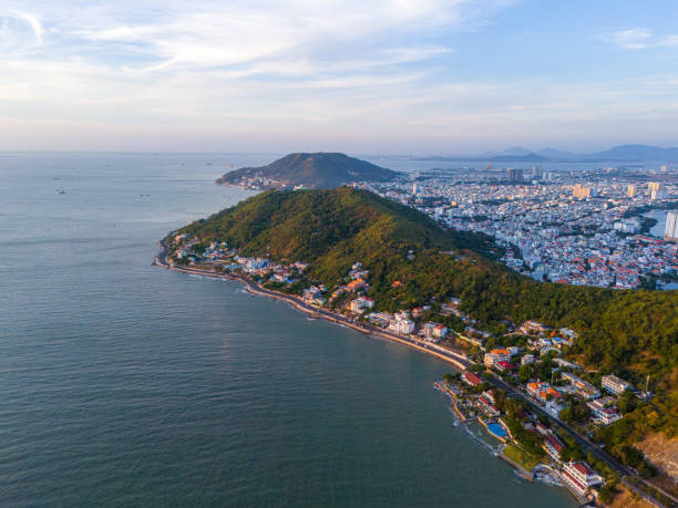 istock Panoramic coastal Vung Tau view from above, with waves, coastline, streets, coconut trees, Mount Nho in Vietnam behind the statue of Christ the King 1864670480