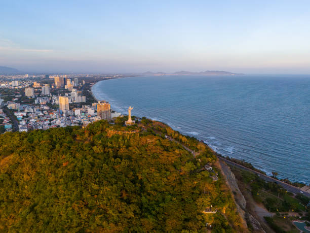 istock Panoramic coastal Vung Tau view from above, with waves, coastline, streets, coconut trees, Mount Nho in Vietnam behind the statue of Christ the King 1864670490