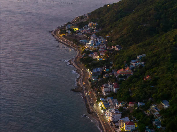 istock Panoramic coastal Vung Tau view from above, with waves, coastline, streets, coconut trees, Mount Nho in Vietnam behind the statue of Christ the King 1864677155