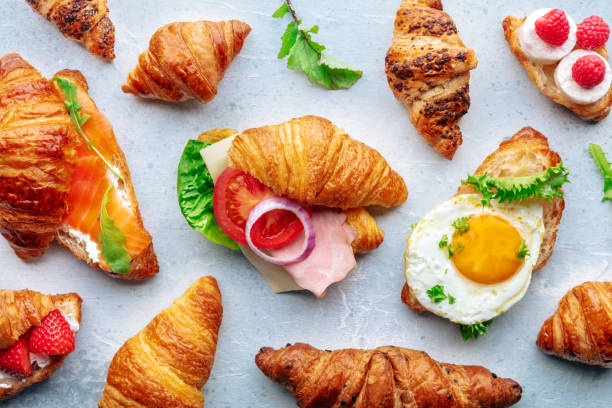 istock Croissant sandwich assortment. Many stuffed croissants, overhead flat lay 1864683106