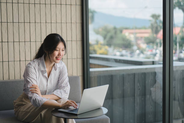 istock Smiling young asian businesswoman using laptop to work online, remote work. 1864683697