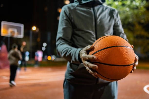 istock Male basketball player holding ball while standing. 1864687737