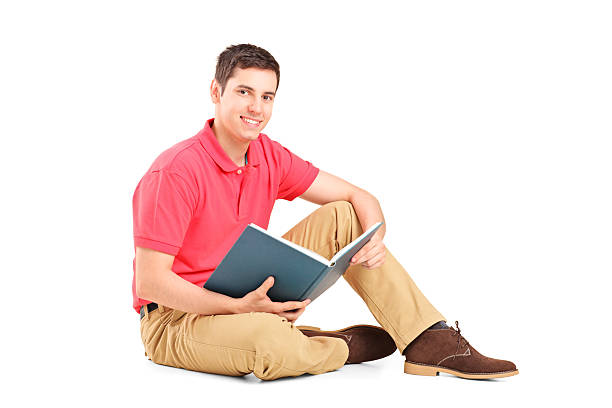 istock Young handsome guy sitting on a floor and reading book 186468933