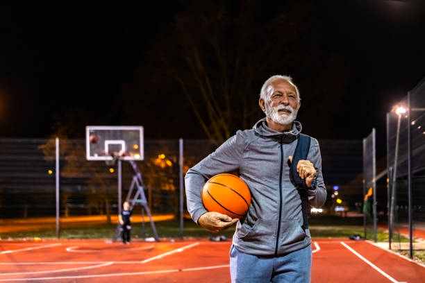 istock Senior Basketball Player Holding A Ball 1864691780