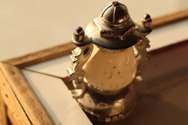 istock A Small white and silver light lantern or lamp toy replica with golden lights and selective focus, tilt shot 1864692628