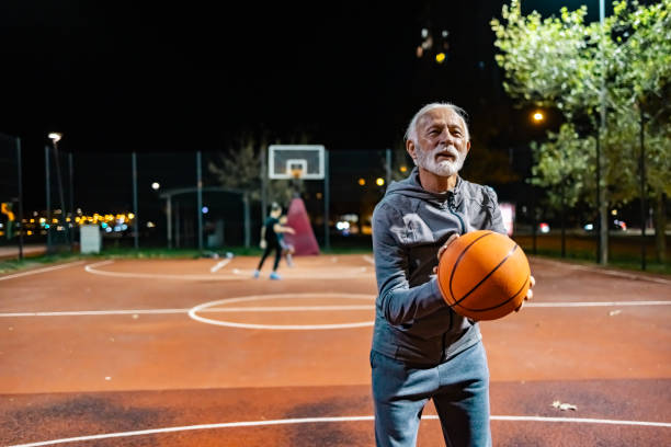 istock Senior man practicing basketball shooting alone 1864693223