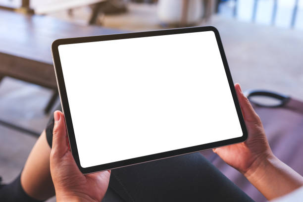 istock Mockup image of a woman holding digital tablet with blank white desktop screen 1864703471