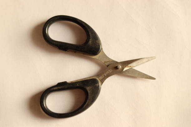 istock A small black stainless steel scissor with black handle, open scissor 1864705141