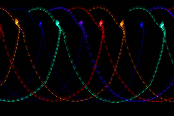 istock Loops of bright multi colored light trails on a black background. 1864710578