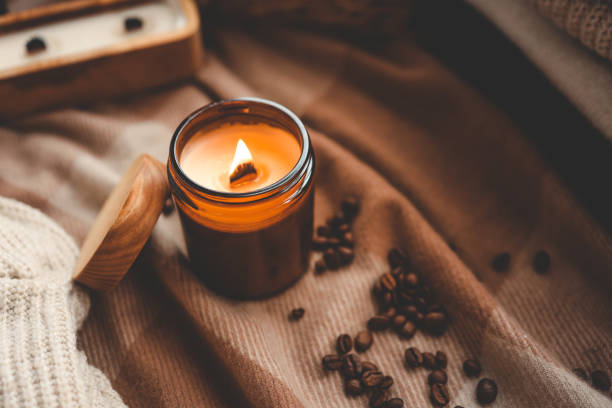 istock Burning candle and coffee beans, cozy photo 1864711640