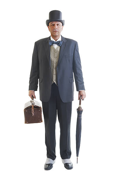 Middle aged  businessman in a retro business suit with valise and umbrella isolated on white.