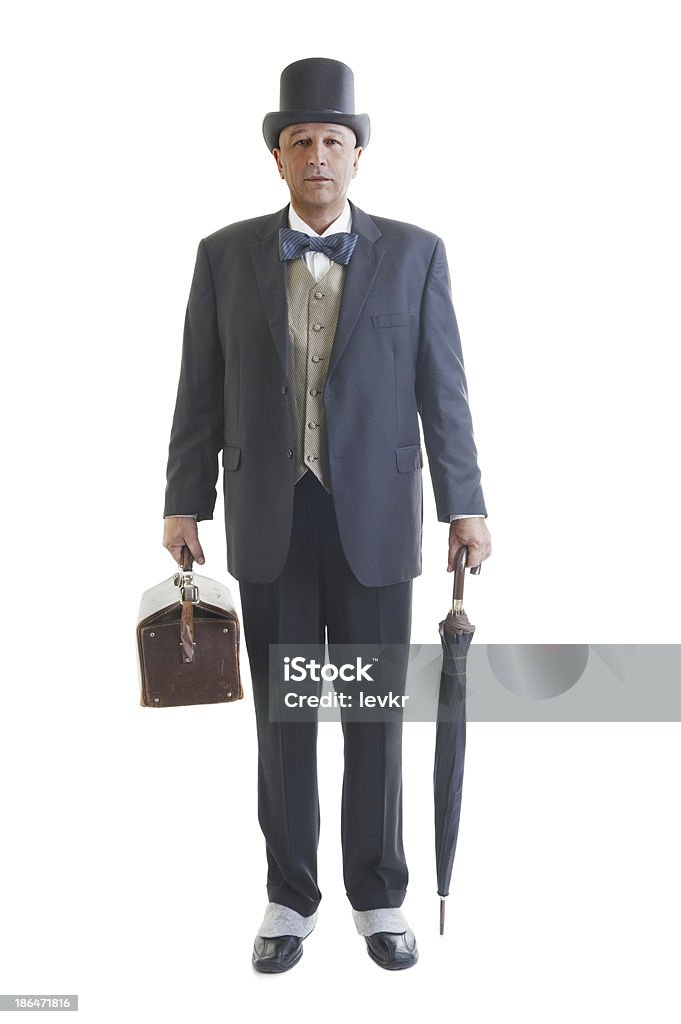 businessman in a retro business suit Middle aged  businessman in a retro business suit with valise and umbrella isolated on white. Top Hat Stock Photo