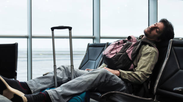 istock Man stuck at the airport sleeping 1864720684