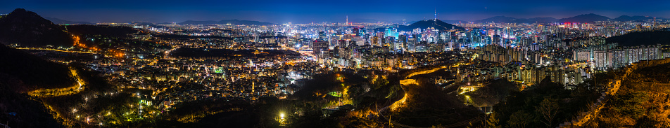 Aerial panorama over the illuminated night cityscape of central Seoul, South Korea’s vibrant capital city.