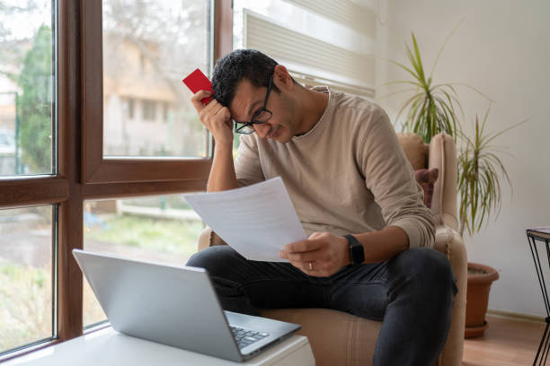Unhappy Man Feel Worry About Financial Problems At Home