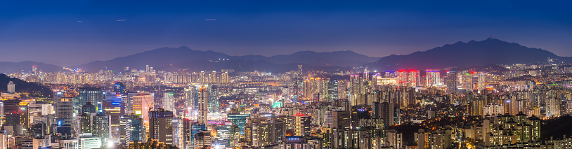 Aerial panorama over the illuminated night cityscape of central Seoul, South Korea’s vibrant capital city.