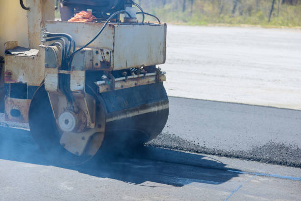 istock An asphalt roller is used by a worker during construction of new road 1864782250