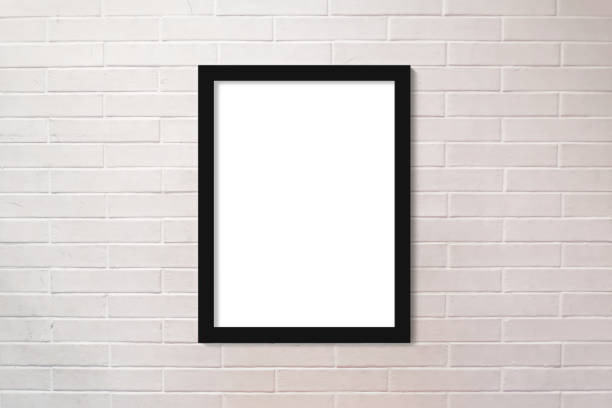 istock Brick wall painted in white and a vertical picture frame 1864791362