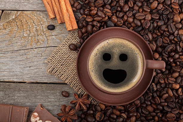 Coffee cup with spices and chocolate on wooden table texture