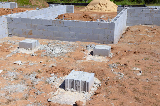 istock Construction site with foundation cement blocks that will support wall of a house 1864794509