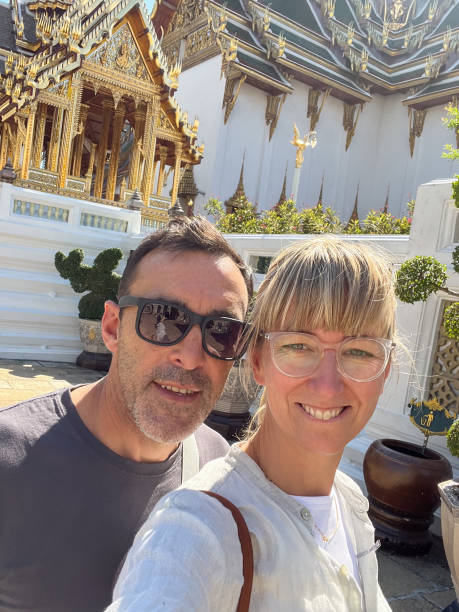 istock Young couple taking selfies at famous places in Bangkok 1864806830