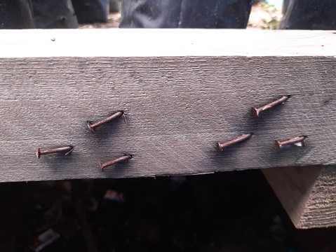 several nails stuck in the wood