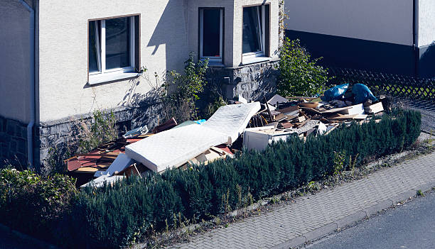 monochrome image of a collapsed burned building with piles of rubble and debris