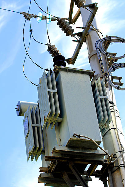 electricity transformer mounted on a tall pole outdoors