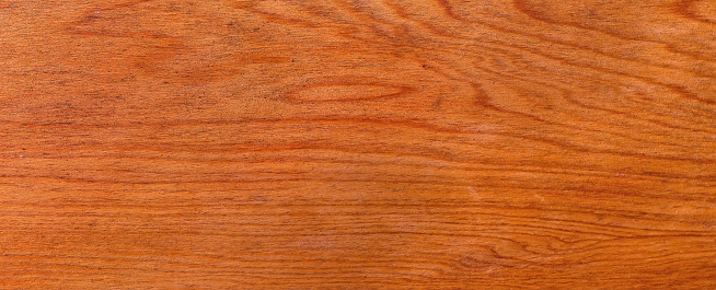 Polished wood texture. The background of polished wood texture with a dark amber color