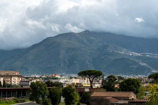 Scenic picture-postcard view of the city of Napoli (Naples) with famous Mount Vesuvius in the background in golden evening light at sunset, Campania, Italy