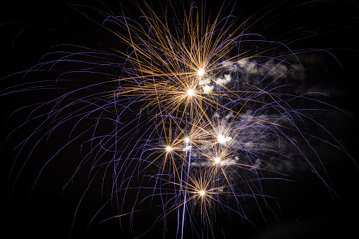 Sparkling burning sparkler on a black background. Isolated burning sparkler, fireworks for holidays Christmas, new year.