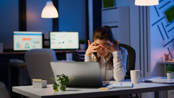 istock Stressed businesswoman suffering from headache at work doing overtime 1864850914