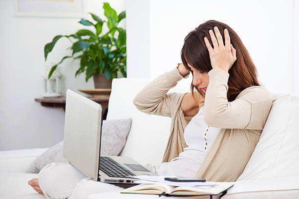 istock Young stressed woman working at home 186485417