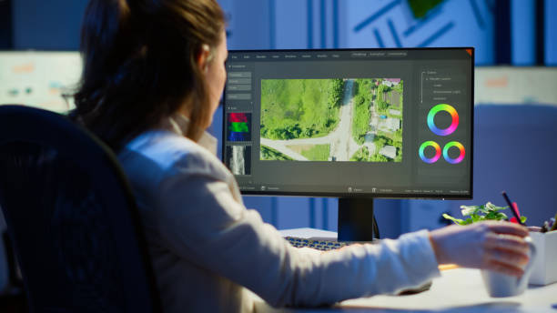 istock Focused videographer editing movie at midnight 1864859702