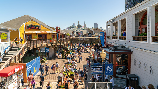 San Francisco, California, USA - 12 August 2019: Fisherman's Wharf is a bustling waterfront district, known for its seafood and souvenir shops, it's a magnet for tourists and locals alike