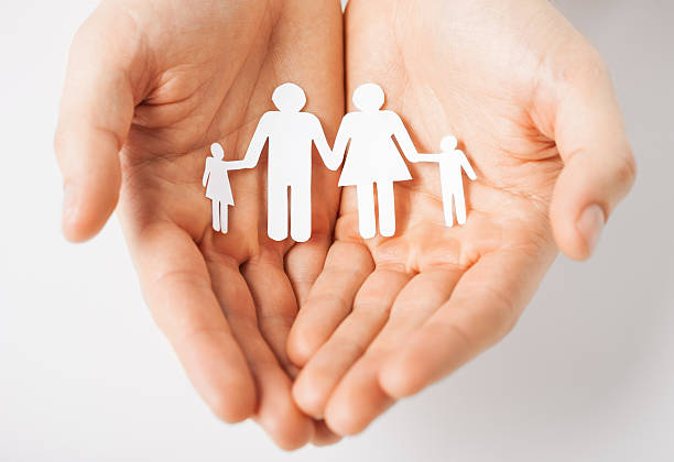 istock male hands holding paper family 186488697