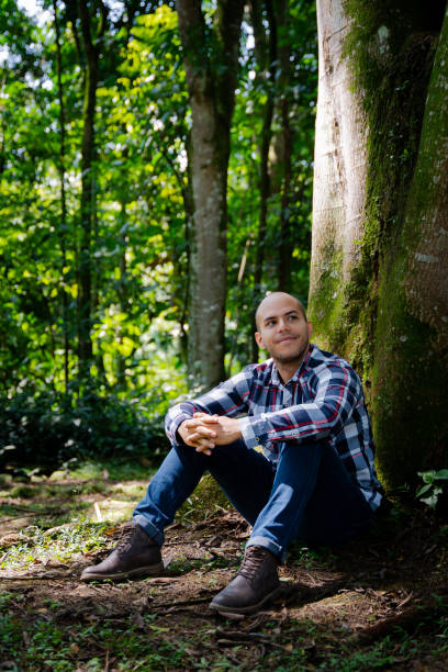 istock Bald man next to a tree in the forest 1864899645