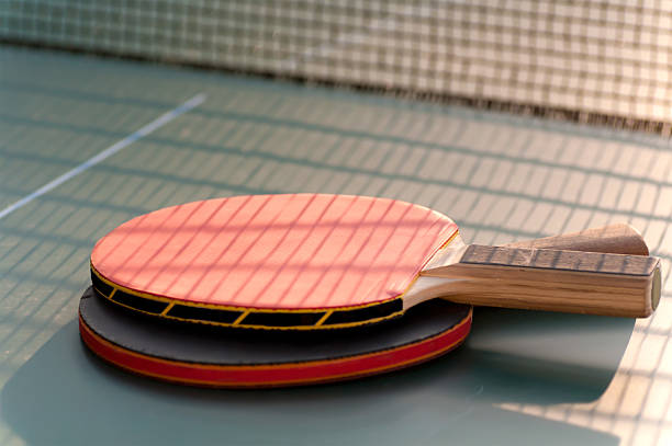 istock two tennis racket on the table near grid 186490264