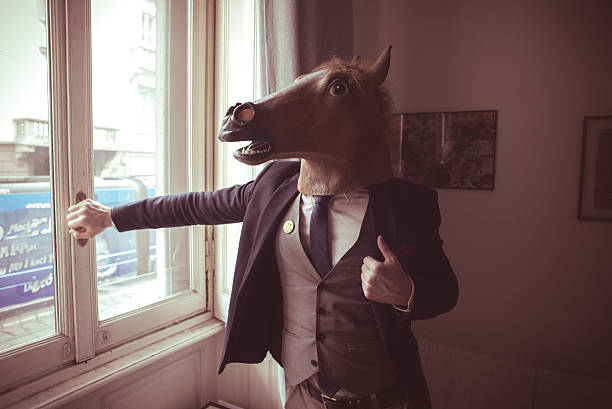 istock horse mask man in front of window 186491261