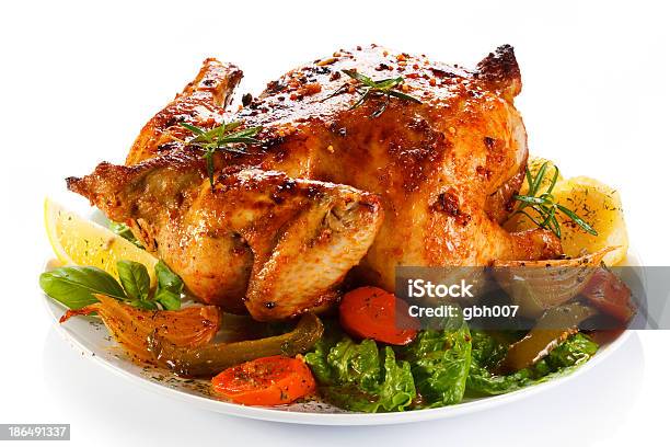 Closeup Of A Roasted Chicken With Vegetables Stock Photo - Download Image Now - Roast Chicken, White Background, White Color