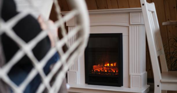 istock Man reading book by fireplace, embodying tranquility in every frame. Cozy, peaceful setting ideal for themes of rest, relaxation. Video exudes calmness, perfect for serene, peaceful content. 1864939149