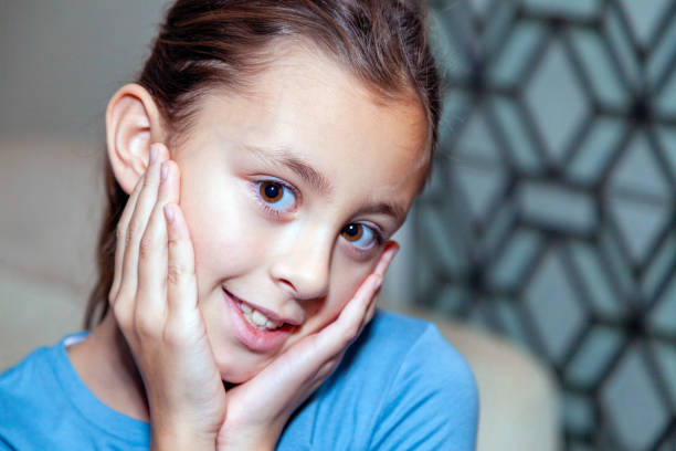 istock Young girl face in hands 1864941755
