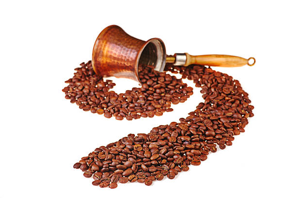 istock black coffee beans leave the copper pot. Selective focus 186494349