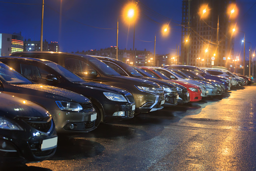 Cars parked at night near store in the city