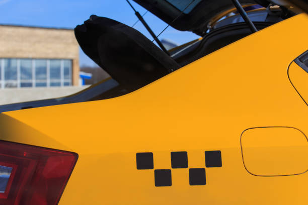 istock Yellow taxi with open trunk 1864946598
