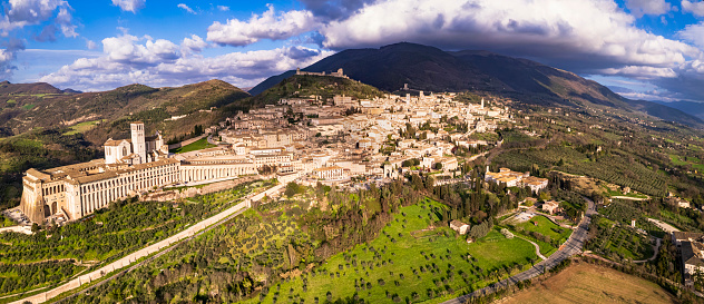 Italy . Impressive medieval Assisi town in Umbria and religious place.  aerial drone panoramic view. italian travel and best destinations
