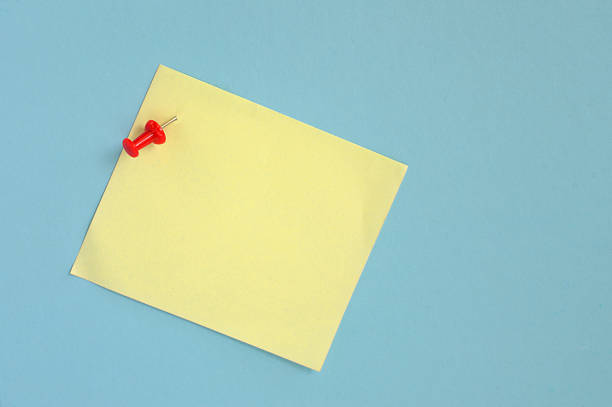 istock Yellow note paper with pin on blue background 186495570