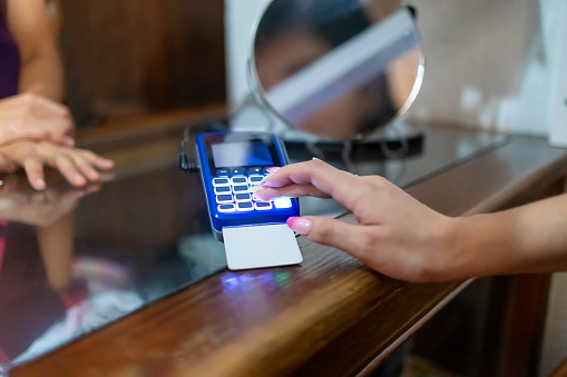 Woman paying for her shoes with a credit card