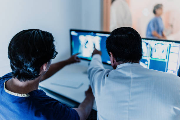 istock Doctors analyzing tomography medical x-ray at hospital 1865004802